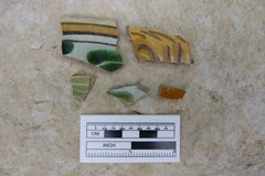 Ceramic fragments next to a ruler for scale
