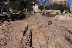 Excavation area next to Alamo Plaza surrounded by fencing