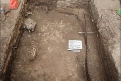 Dirt bottom at bottom of excavation unit with limestone feature