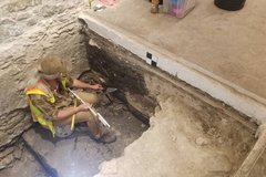 Archaeologist inside an excavation unit