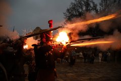 Living historian firing muskets at dawn in Alamo Plaza