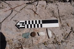 Marker and small rocks on dirt plot