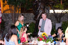 Guests drinking wine enjoying the event in front of the David Crockett statue