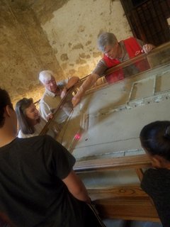Alamo Docent showing a battlefield model to visitors