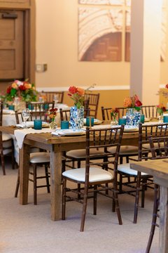 Table set up with place settings and colorful flowers in Alamo Hall