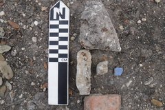 Five artifacts placed next to a rule to show size