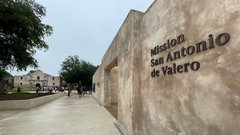 Letters Mission San Antonio de Valero on concrete gate outside of Alamo Church