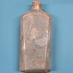 Intact glass bottle worn from time