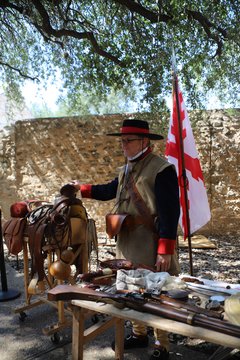 Living historian demonstrating weapons in the encampment