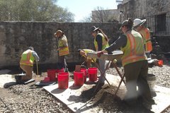 Archaeologists working in the exterior by Alamo Church