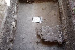 Limestone block aligned to edge of excavation unit