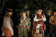 Living Historians holding muskets in Alamo Garden