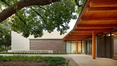 Trees and arbor at entrance to signage of Ralston Family Collections Center