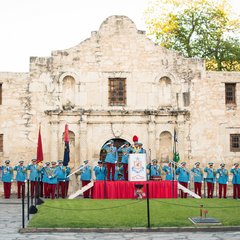 Texas Cavaliers lined up in full uniform in front of Alamo Church