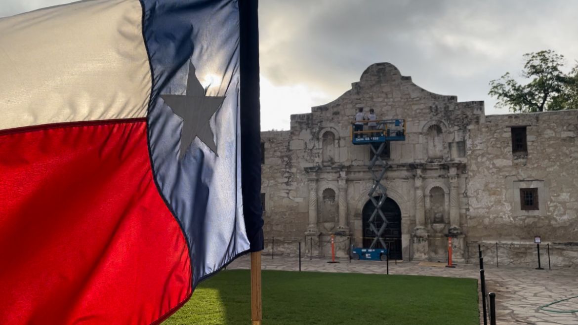 Texas flag flying in front of Alamo Church