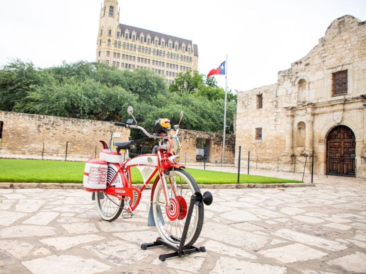 Red bicycle with white trim in Alamo Plaza