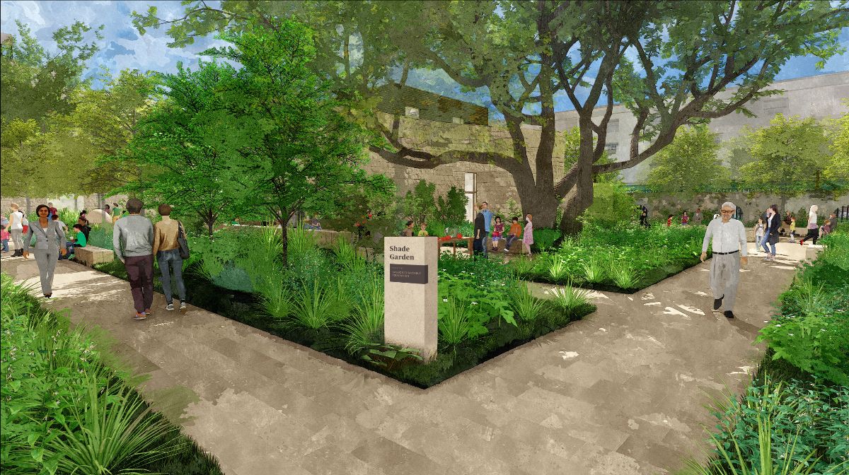 Monument sign in a garden area under a large live oak tree