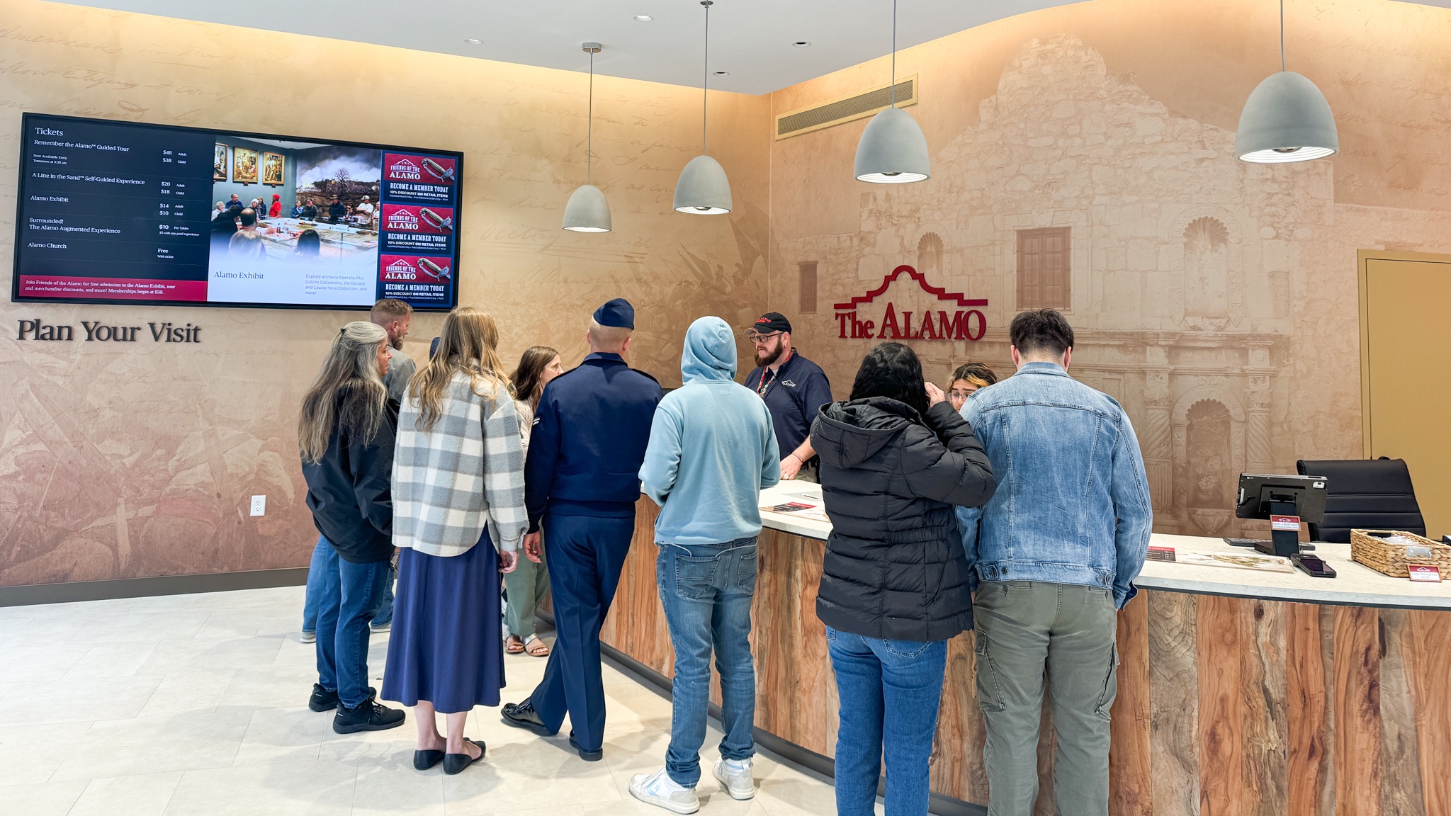 Group of people gathered at check out inside a retail area