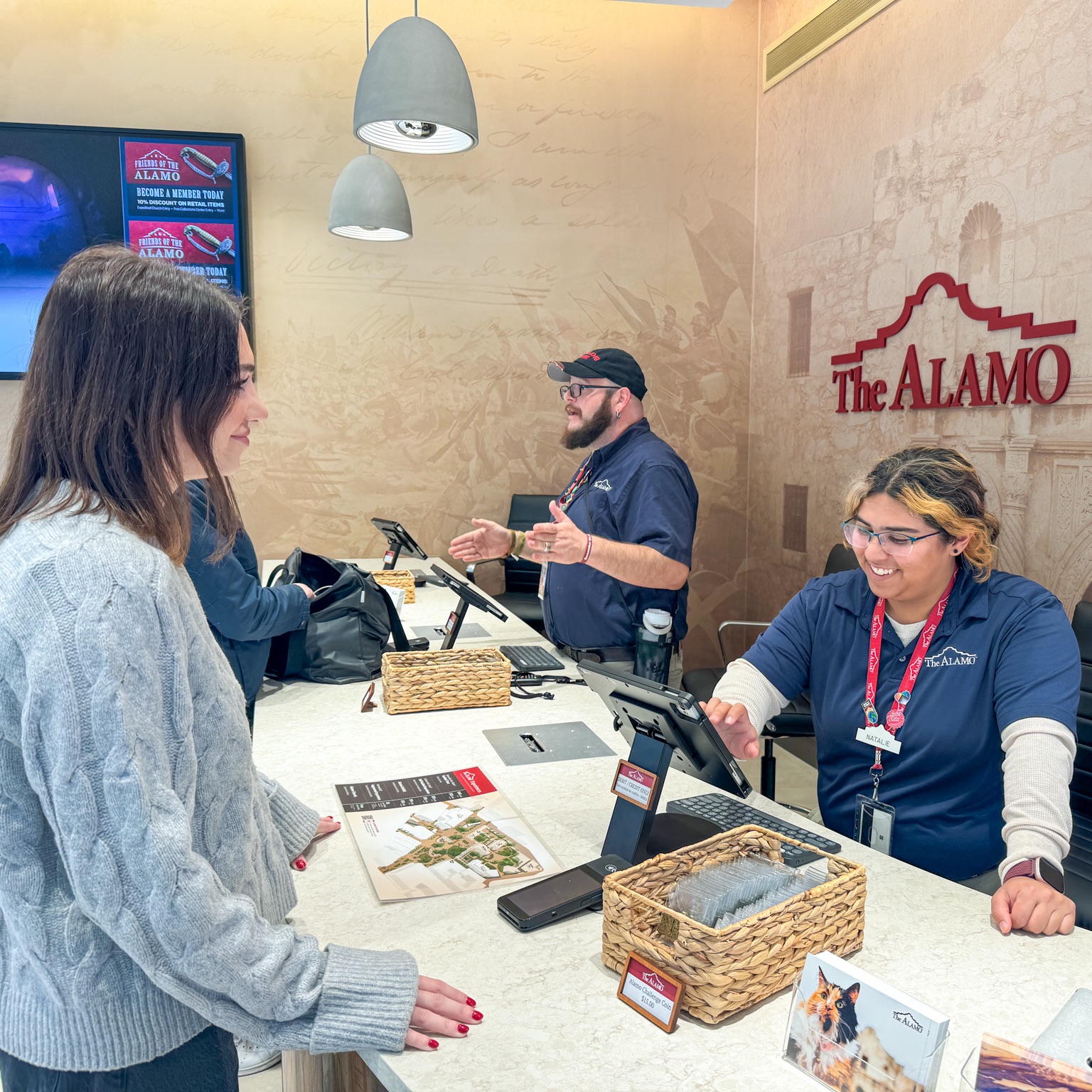 Associate helping a guest at a checkout station