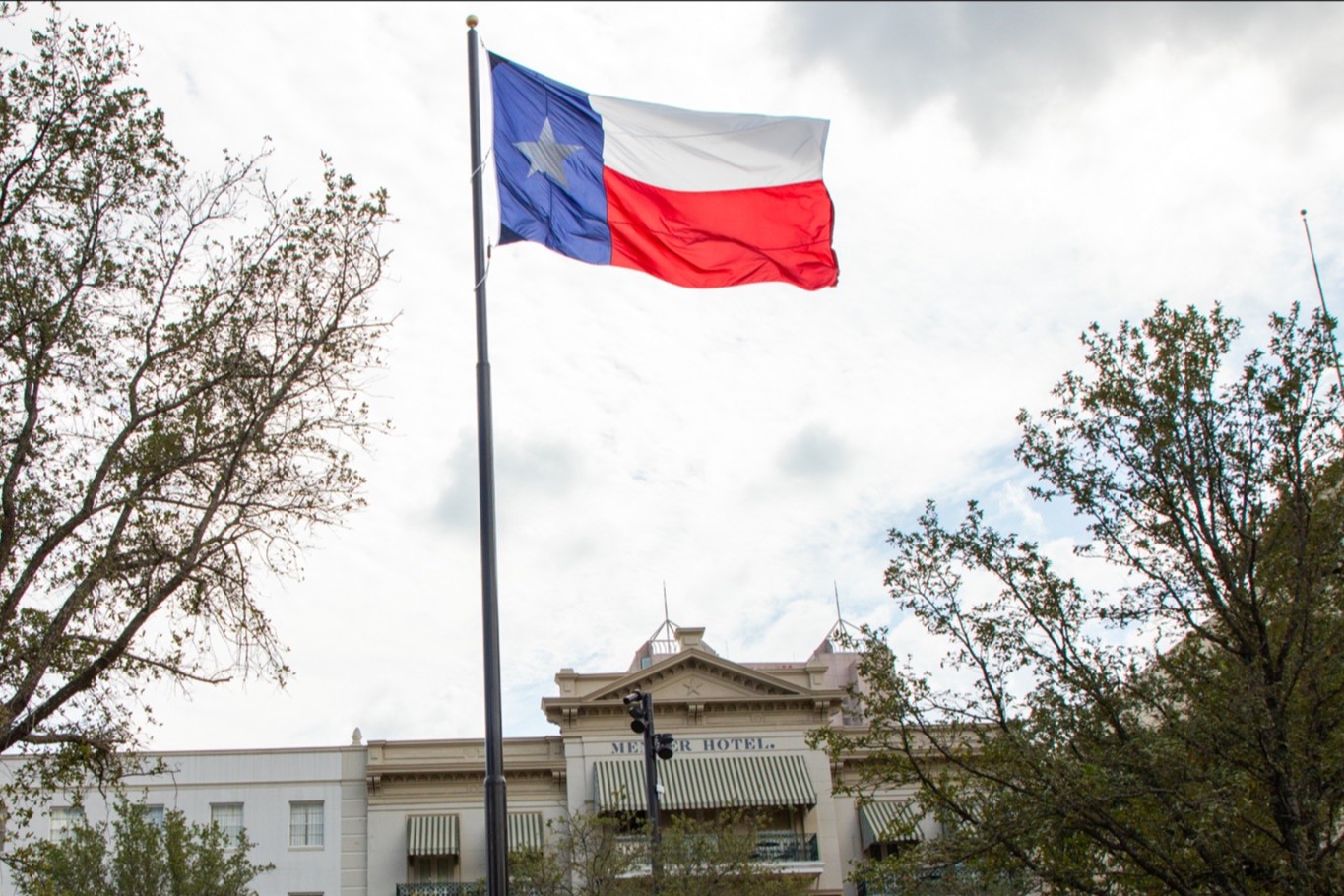 Texas flag flying in Plaza de Valero in front of Menger Hotel