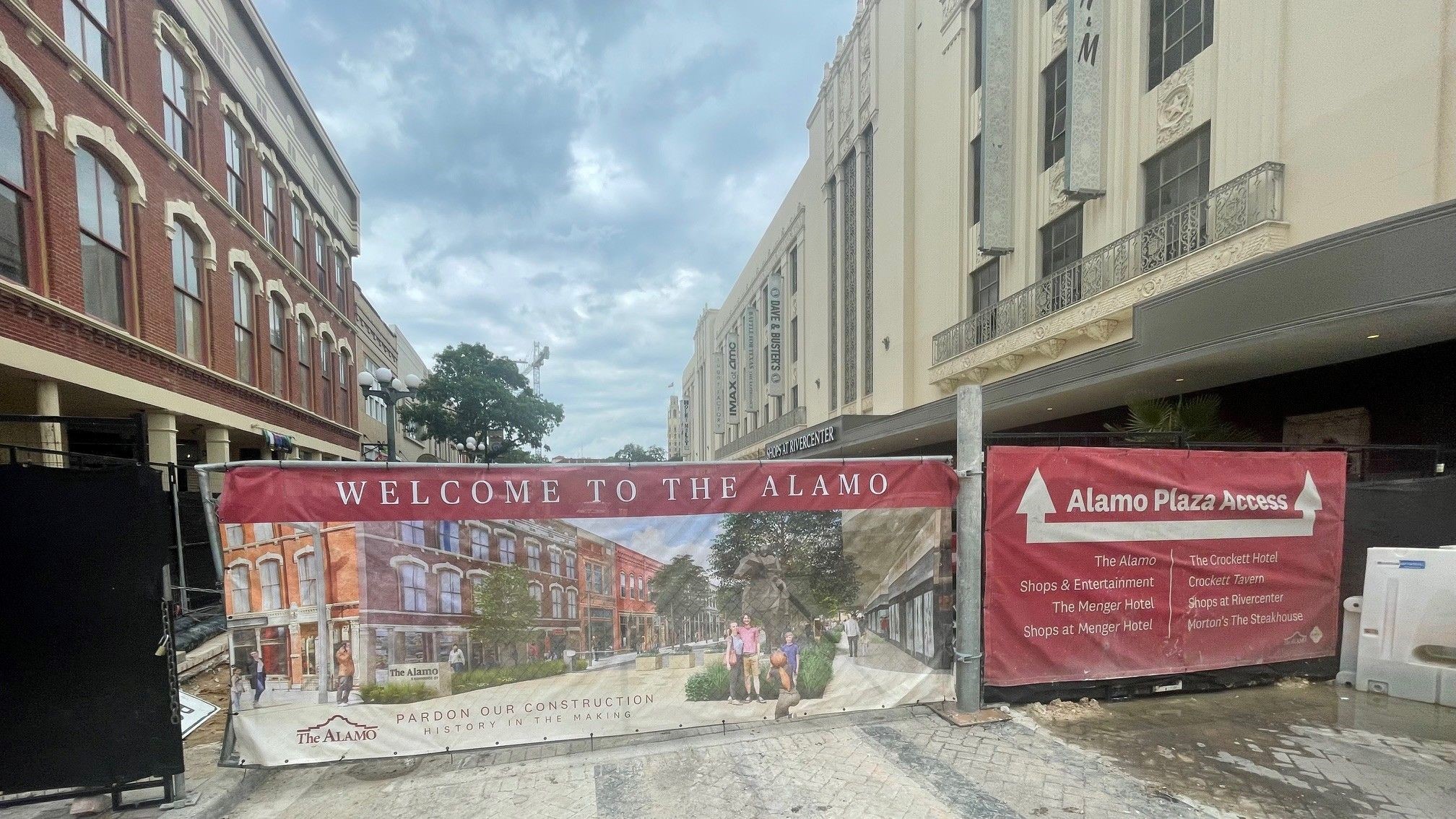 Wrap with downtown promenade rendering over a fence