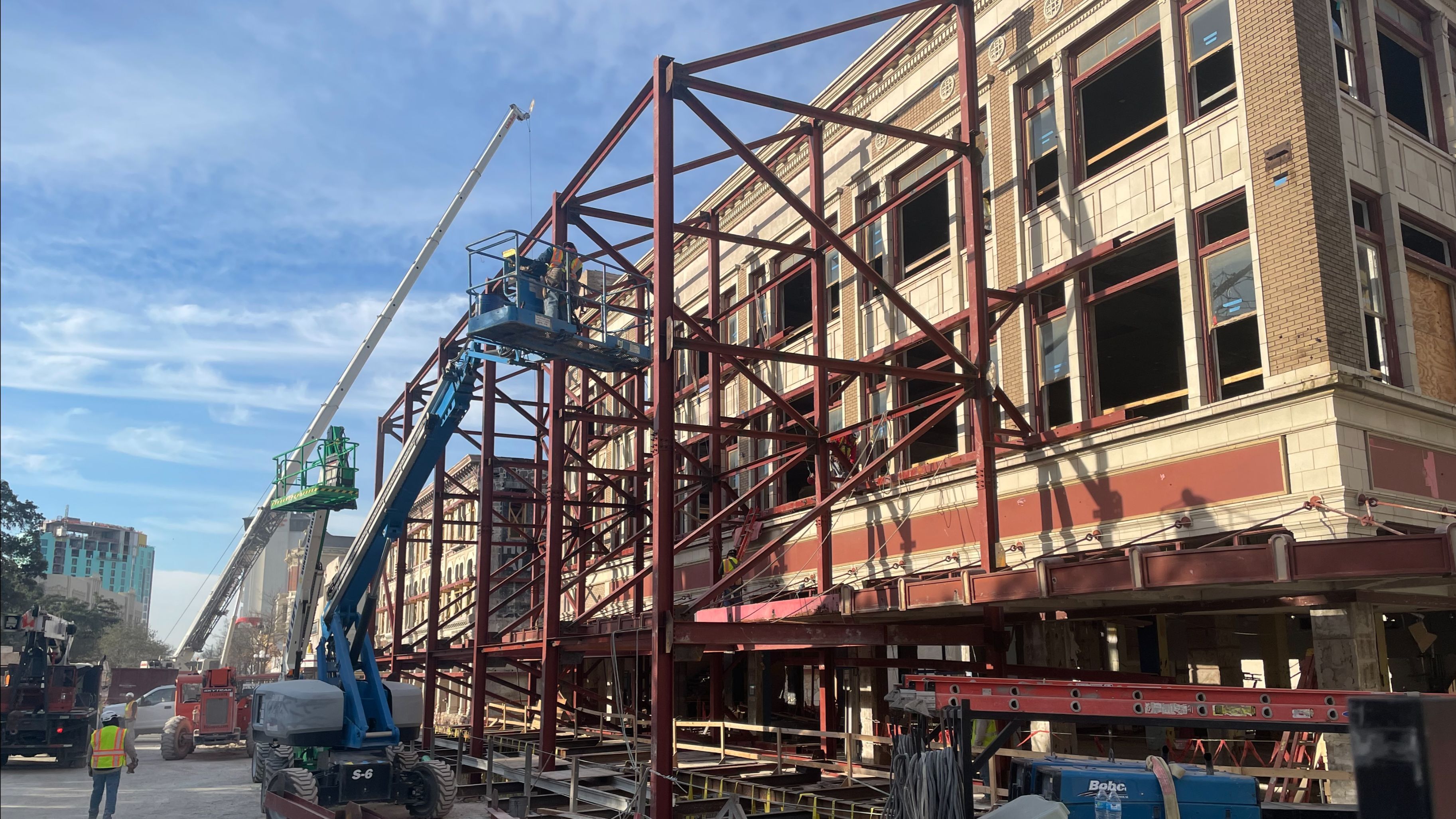 Multiple tall cranes outside of Crockett Building under construction