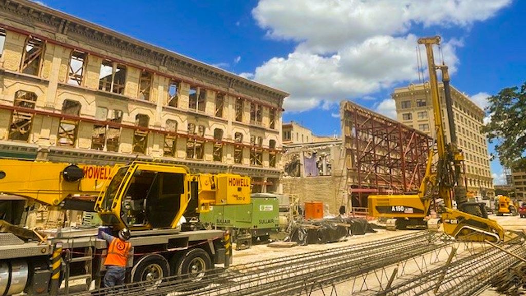 Construction trucks outside Crockett and Woolworth Buildings