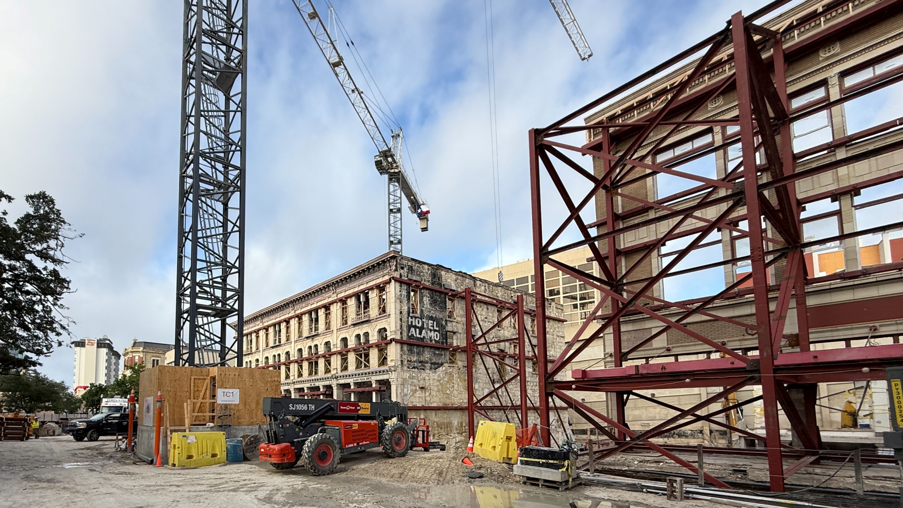 Large crane outside of Crockett Building facade under construction
