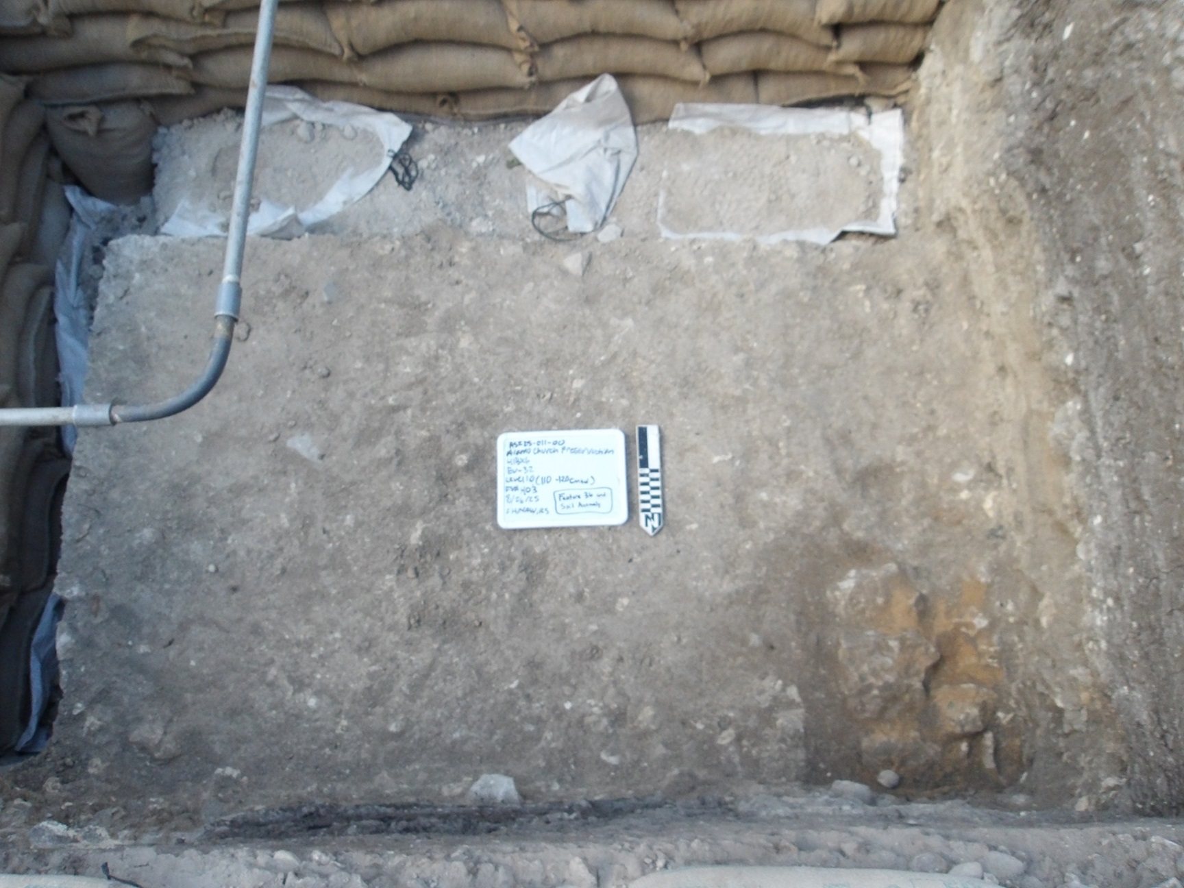 Sandbags lining border of interior of excavation unit