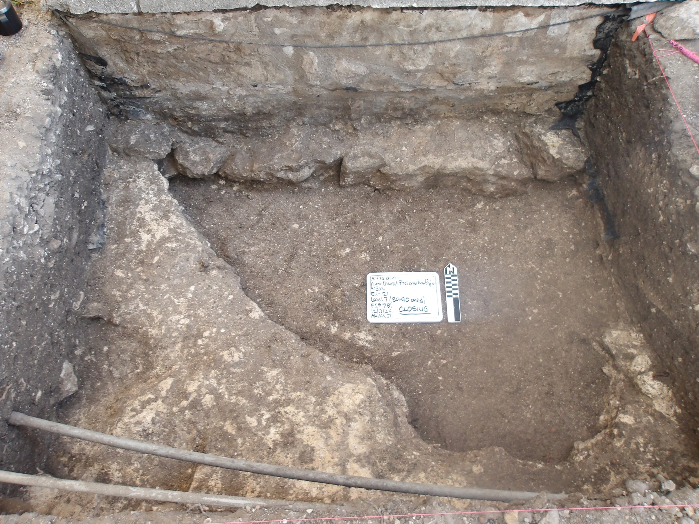 Triangular limestone deposit at the bottom of an excavation unit
