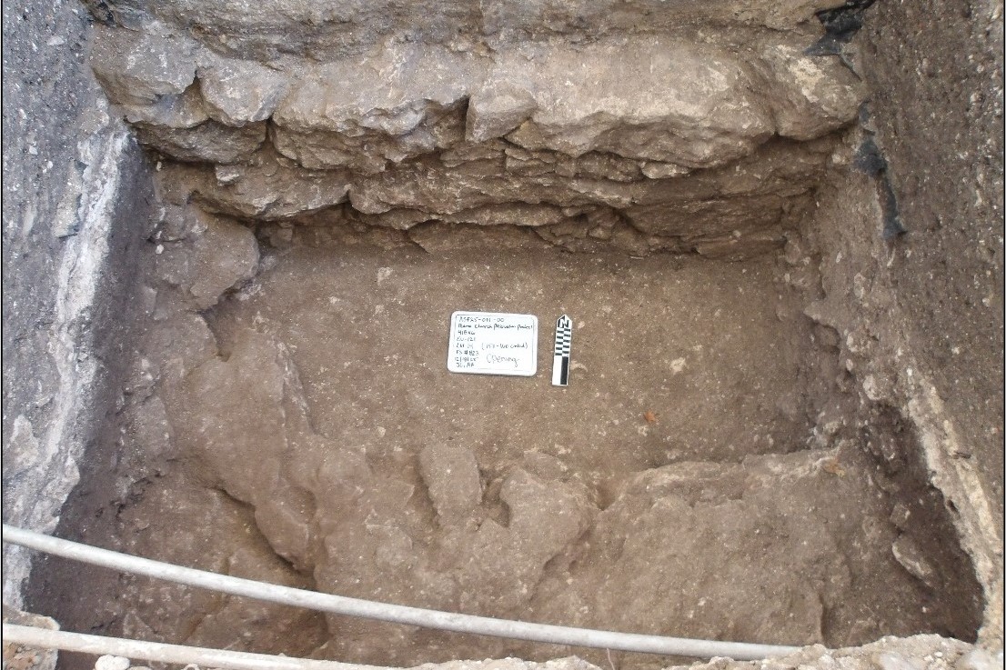 Two pipes across bottom of excavation unit