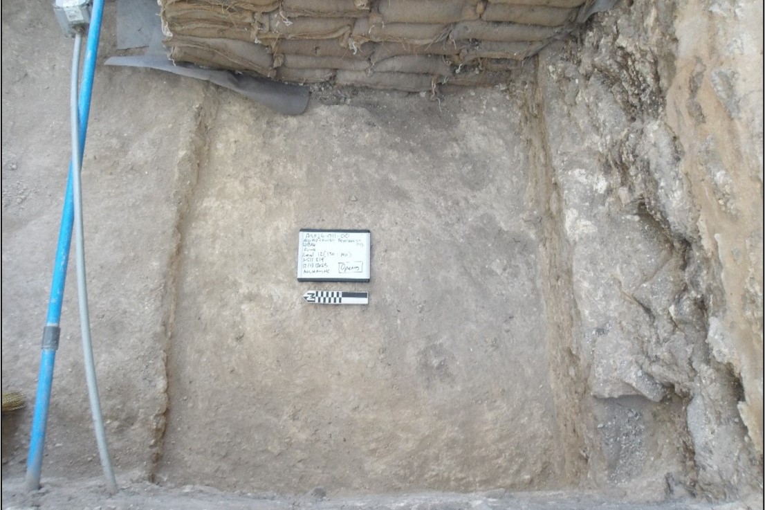 Blue pipe and sandbags inside an excavation unit