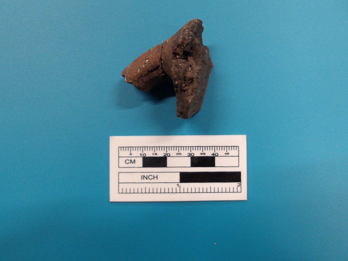 Goliad ceramic handle on a blue background next to a ruler for size