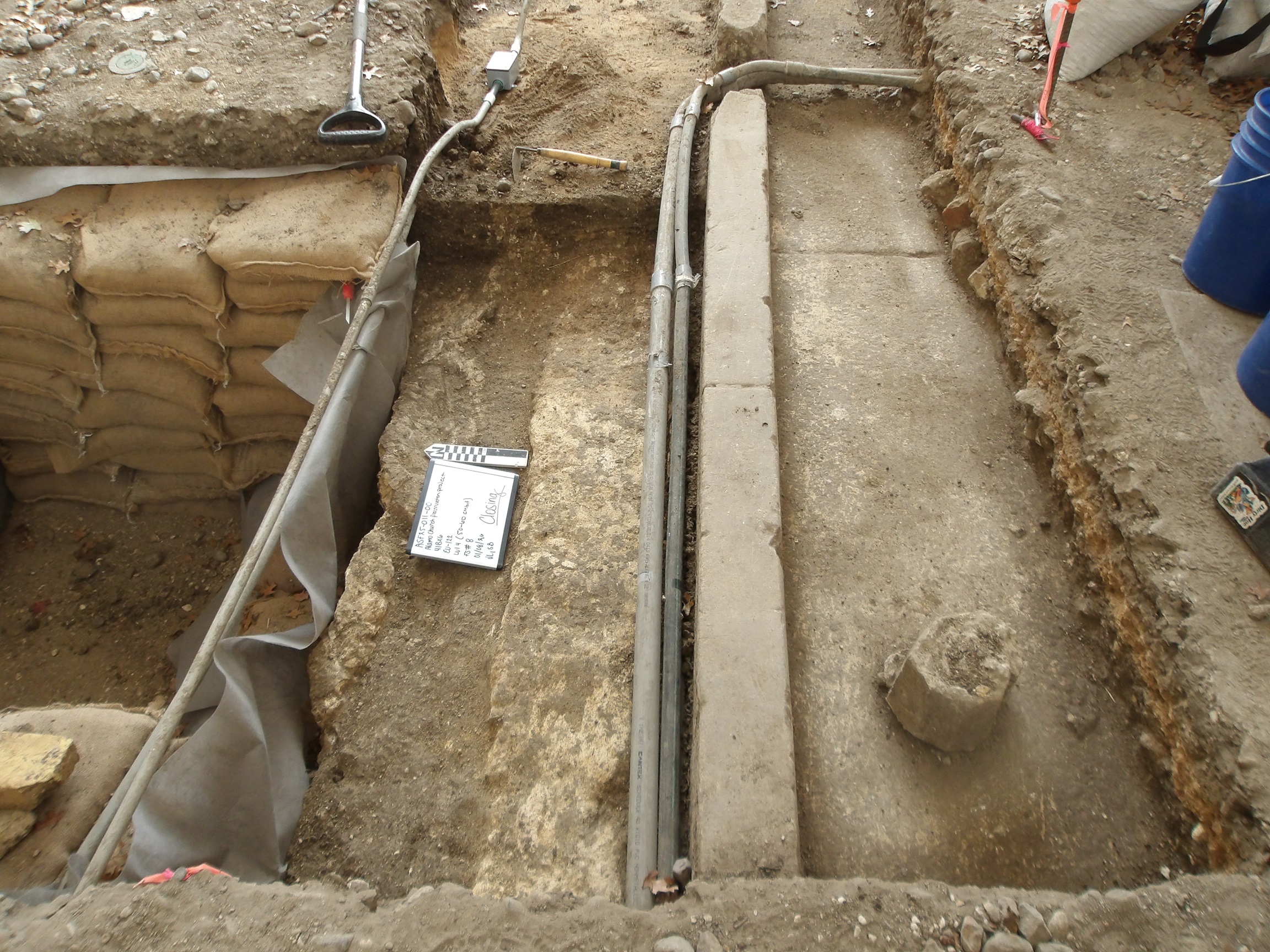 Concrete curb and slab inside an excavation unit