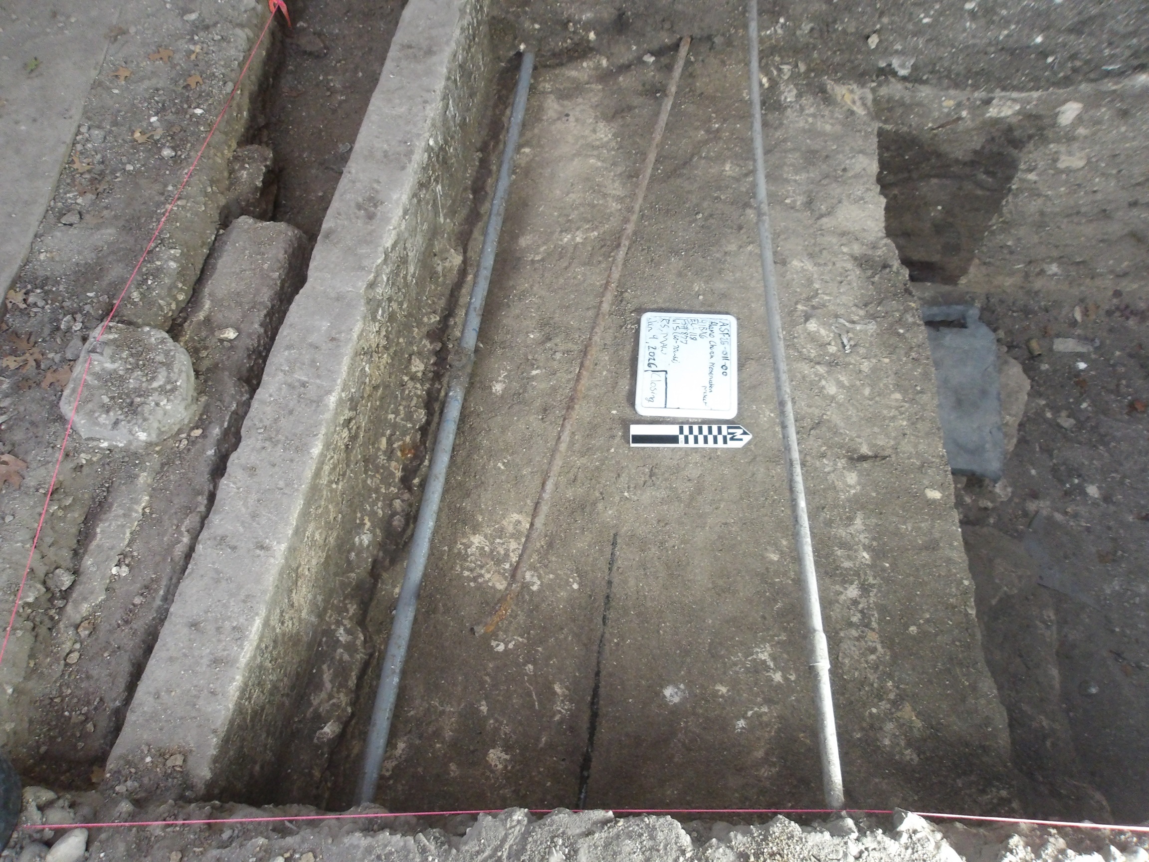 Utilities and soil deposits inside an excavation unit