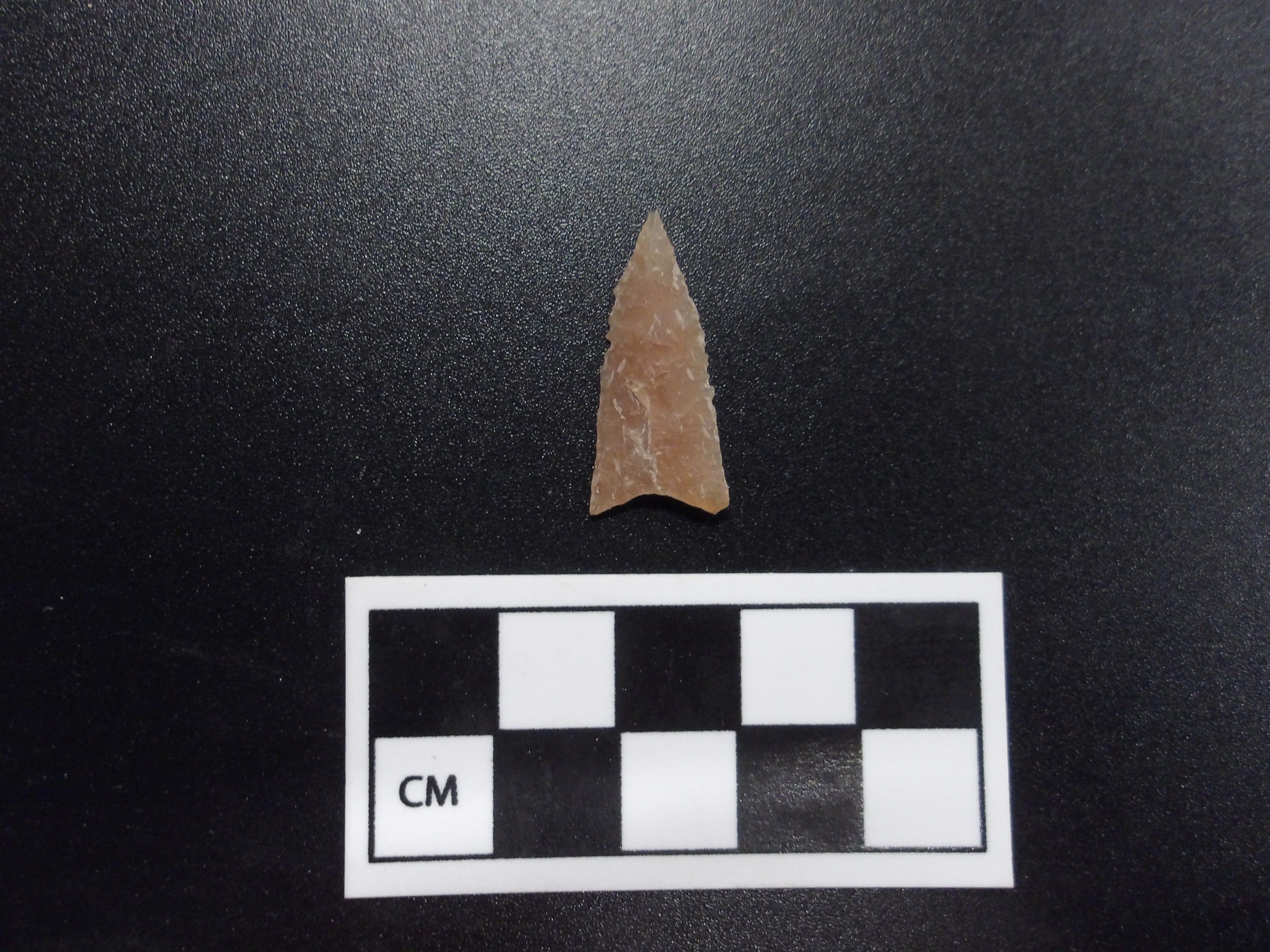 Guerrero point on a black background next to a ruler for size