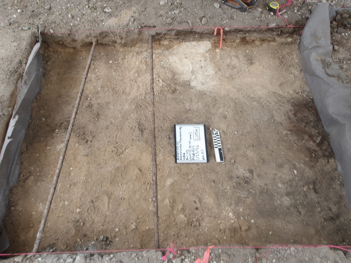 Flat surface with two pipes 40 cm below surface in an excavation unit