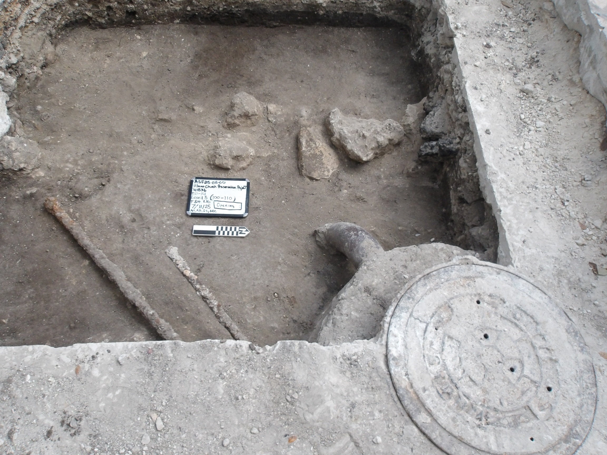 Inside of an excavation unit with an abandoned manhole at the bottom corner