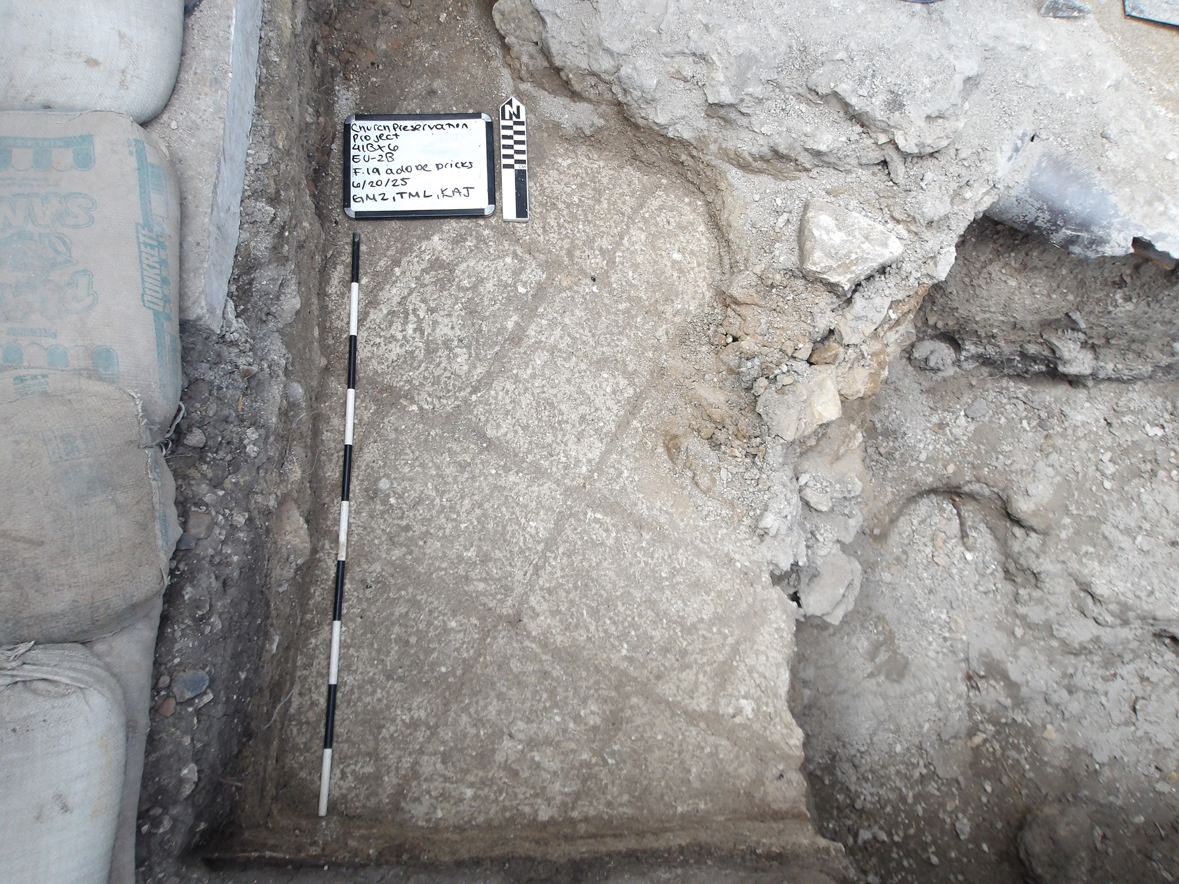 Inside of an excavation unit exposing adobe pavers found at the bottom