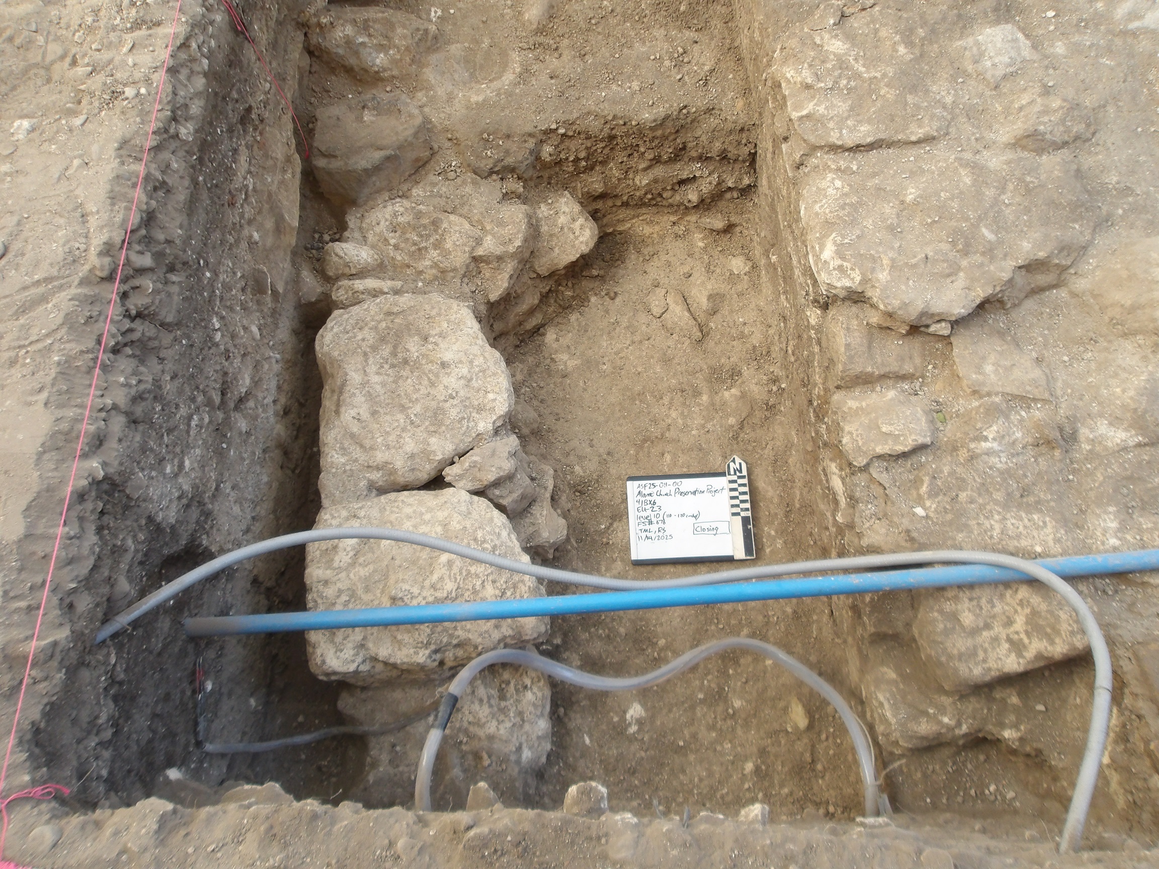 Three limestone rock features at the bottom of an excavation unit