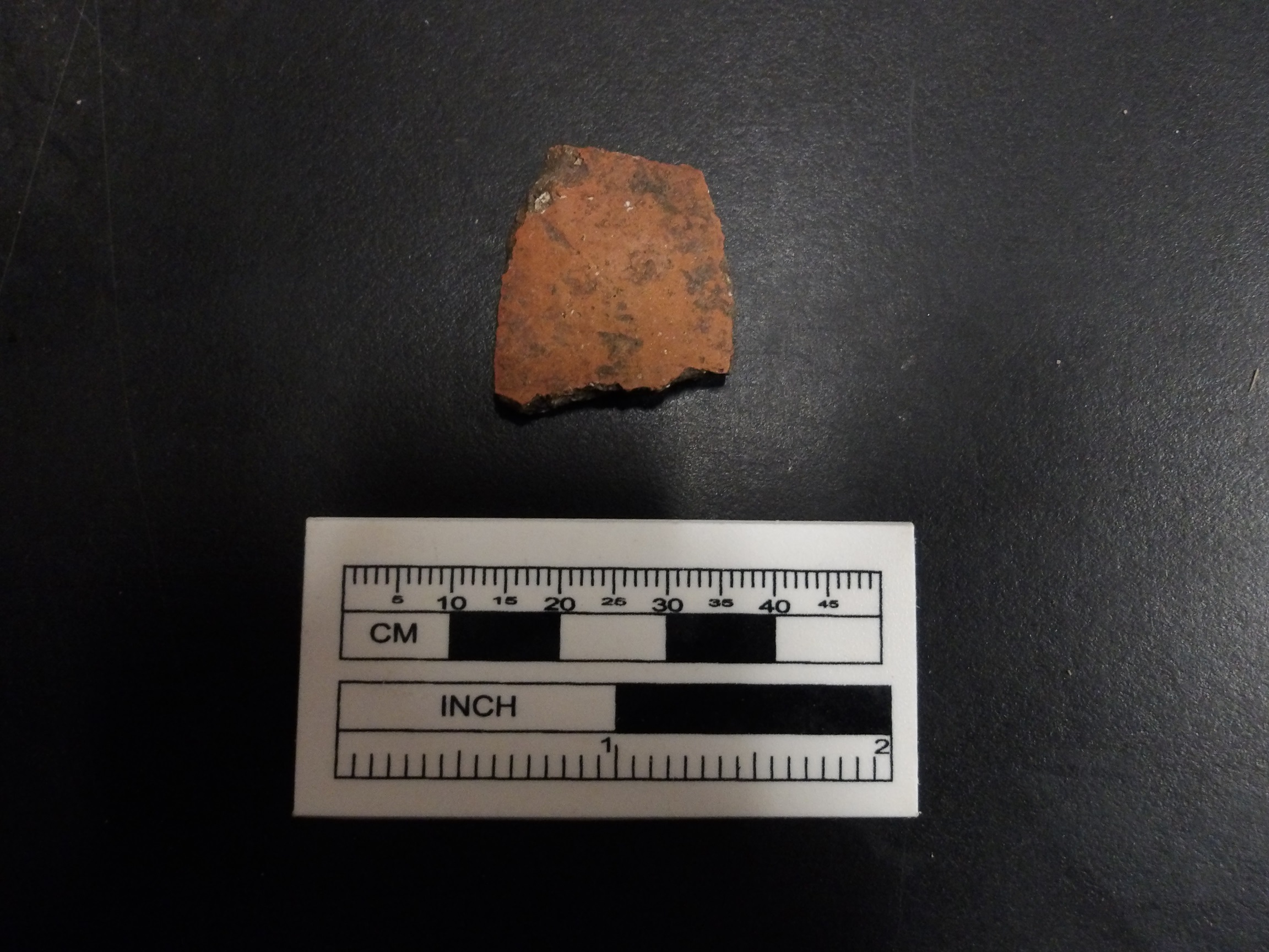 Goliad sherd next to a ruler for size