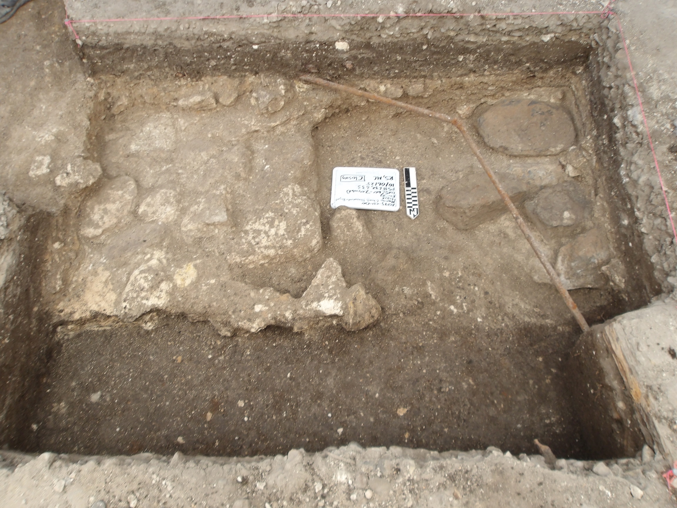Dirt row in front of limestone feature at bottom of excavation unit