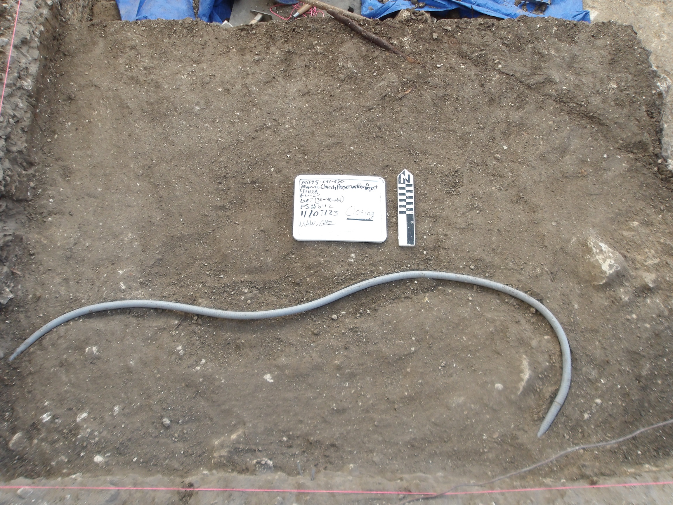 Bottom of excavation unit with a curved tube across the middle area