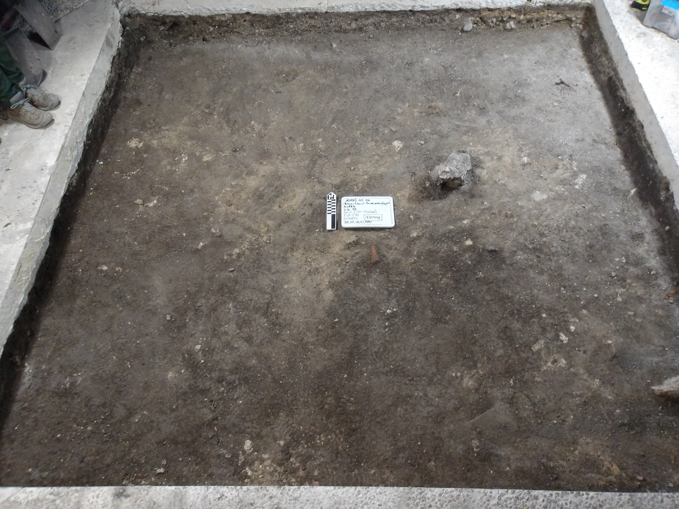 Dark dirt bottom of an excavation unit