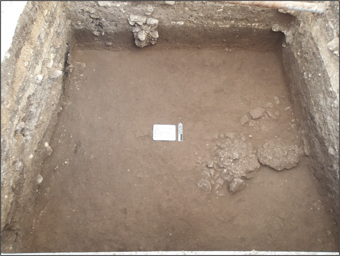Natural caliche hardpan at bottom of excavation unit