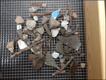 Glass, metal, and European earthenware ceramic recovered from an excavation unit